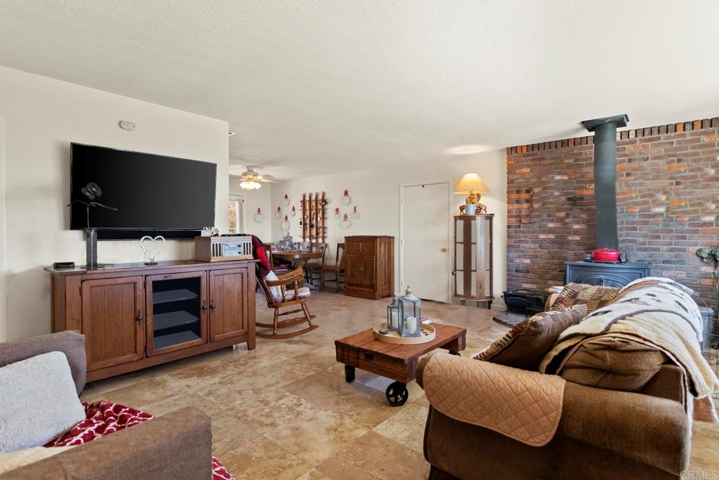 1104 Doomey Drive Ramona, CA 92065 - Photo 7 of 31 a living room with furniture and a flat screen tv