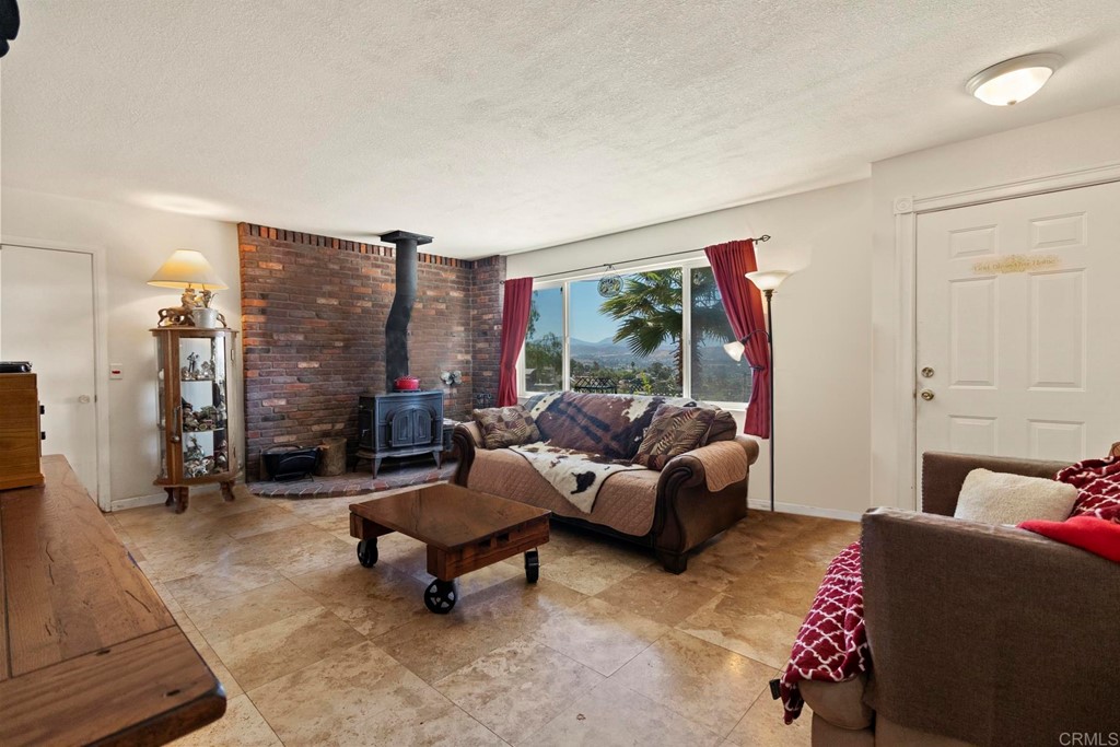 1104 Doomey Drive Ramona, CA 92065 - Photo 8 of 31 a living room with furniture and a large window