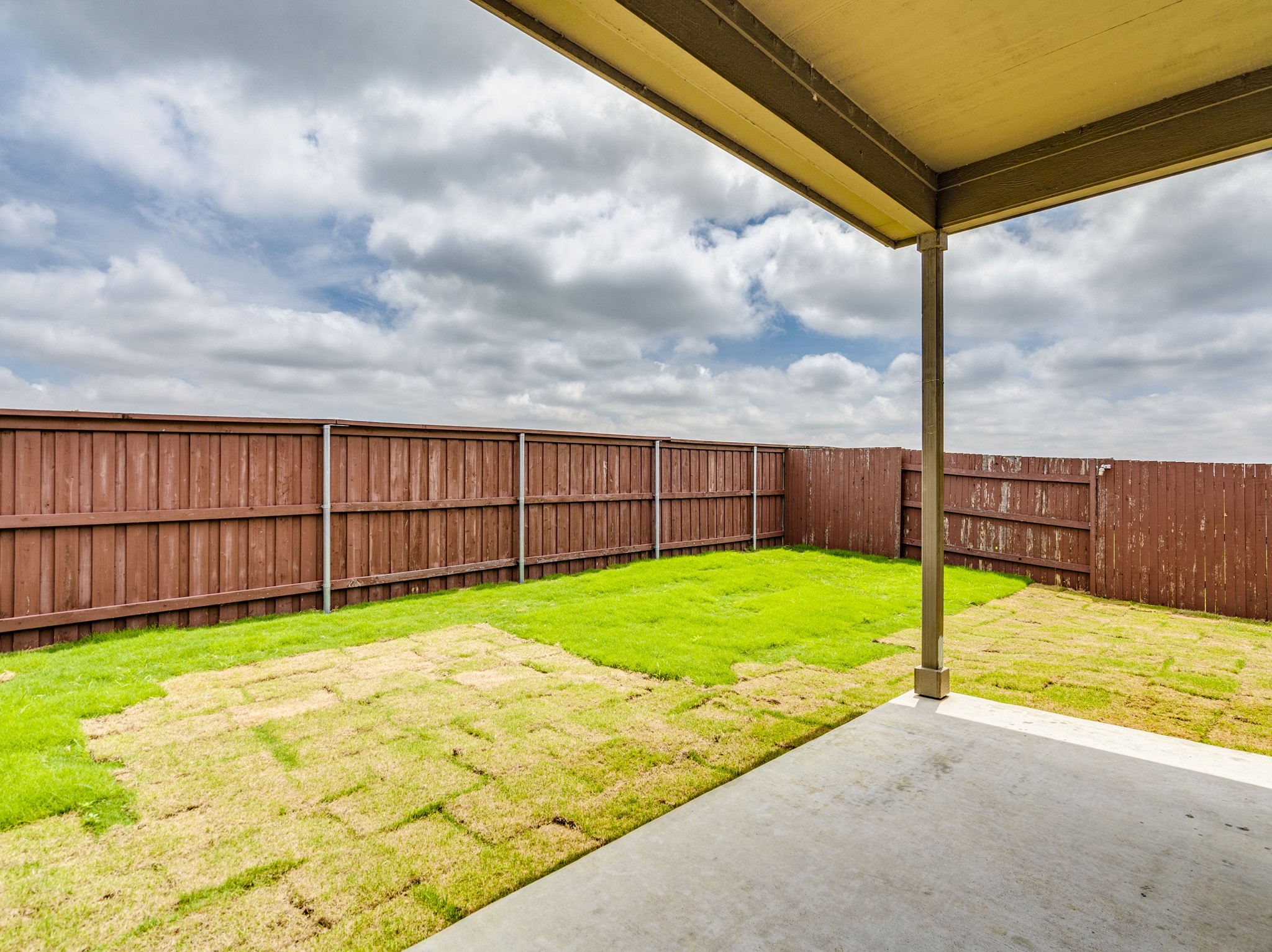 790 Pepperbark Loop Buda, TX 78610 - Photo 21 of 22 A spacious, enclosed backyard with a covered patio, perfect for outdoor leisure.