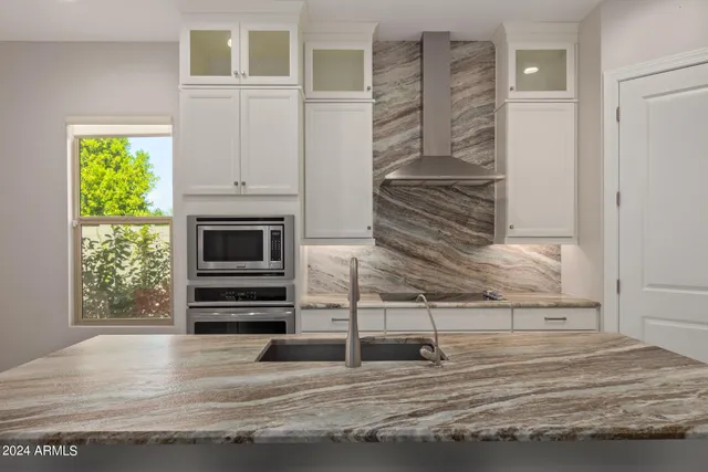 a kitchen with a sink and stainless steel appliances