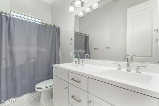 a living room with a flat screen tv and cabinets