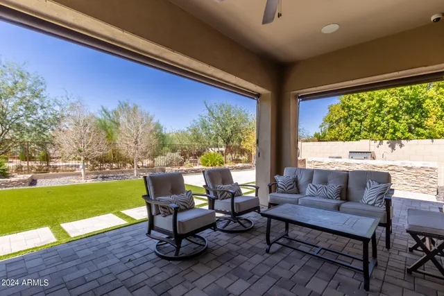 a balcony with wooden floor and outdoor seating