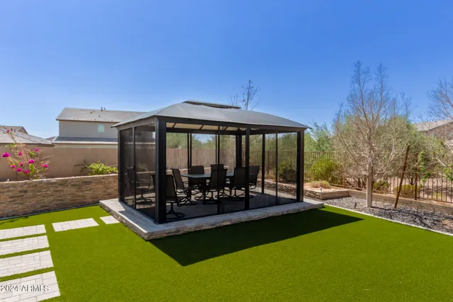 a view of a house with a backyard patio and swimming pool