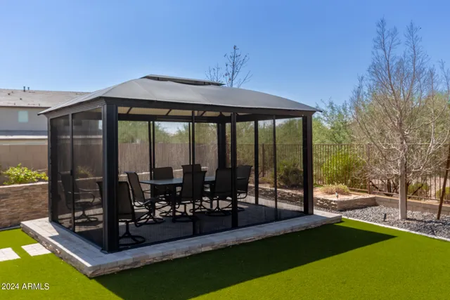 a view of a patio with table and chairs next to a yard