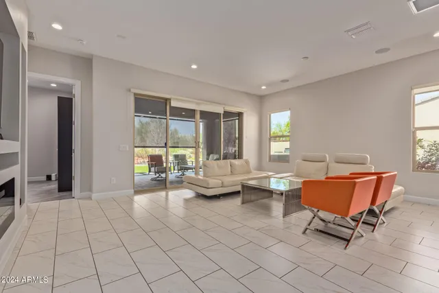 a living room with furniture and floor to ceiling window