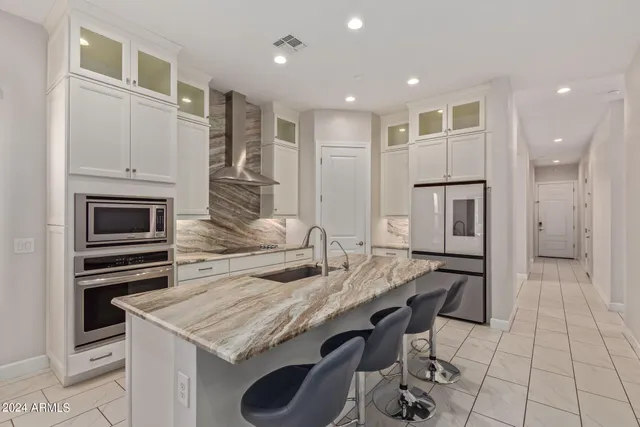 a kitchen with kitchen island granite countertop a sink and counter space