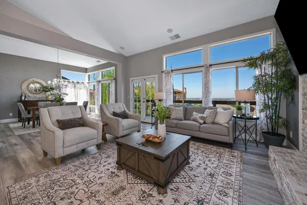 a living room with furniture potted plant and a window