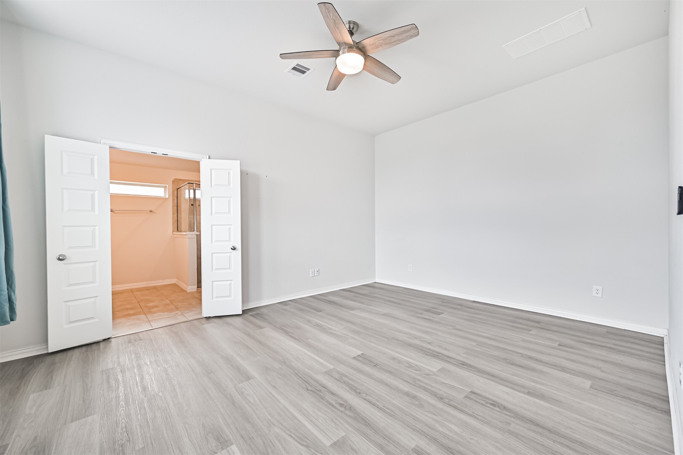 7019 Terra Drive Manvel, TX 77578 - Photo 32 of 41 an empty room with wooden floor a ceiling fan and entryway