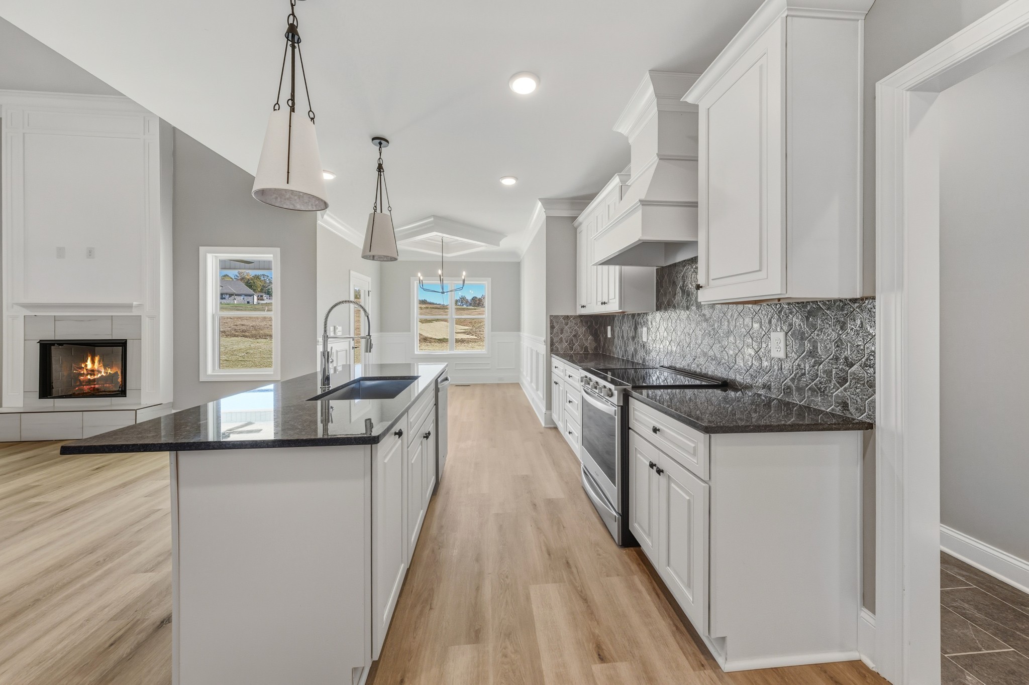 1675 Sulphur College Road Hartsville, TN 37074 - Photo 13 of 42 a kitchen with stainless steel appliances granite countertop a sink a stove and a wooden floors