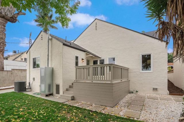 a view of a chairs and table in the backyard