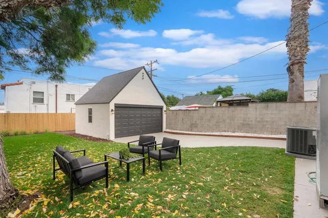 a white house that has a tree in front of it
