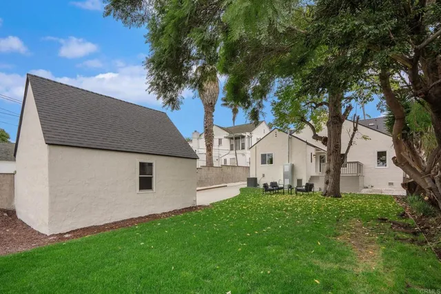 a front view of a house with a garden and yard