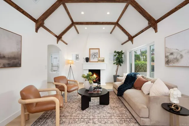a living room with furniture a fireplace and a flat screen tv