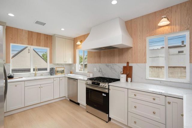 a kitchen with a sink stove and cabinets