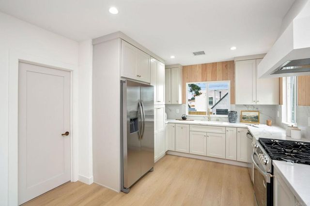 a kitchen with a sink stove and refrigerator