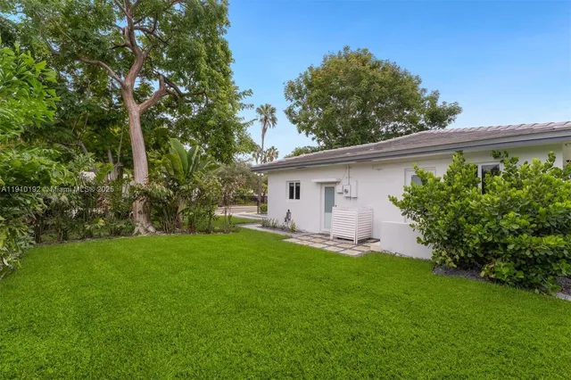 a front view of house with a garden