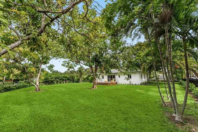 a view of grassy field with benches