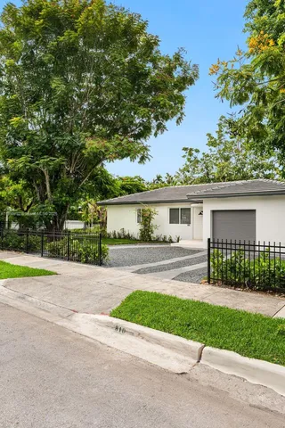 front view of a house with a garden