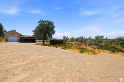 722 West Webb Circle, Unit 2 Draper, UT 84020 - Photo 38 of 39 Gravel driveway with extensive parking, attached garage, and covered carport structure