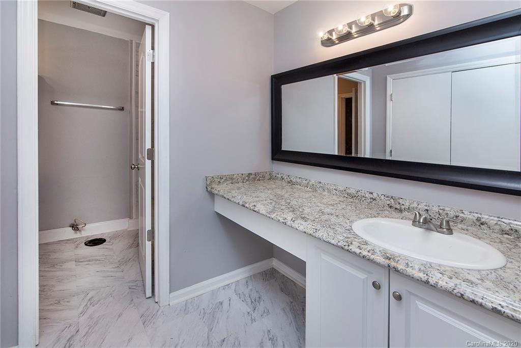 5720 Lawrence Orr Road Charlotte, NC 28212 - Photo 14 of 19 a bathroom with a granite countertop sink and a mirror