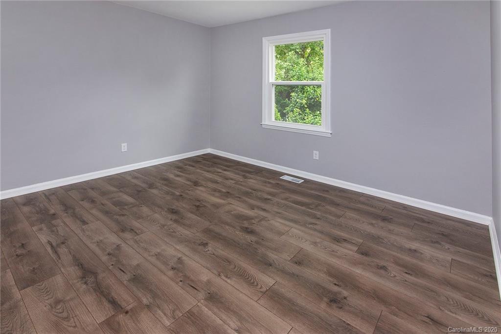 5720 Lawrence Orr Road Charlotte, NC 28212 - Photo 17 of 19 an empty room with wooden floor and windows