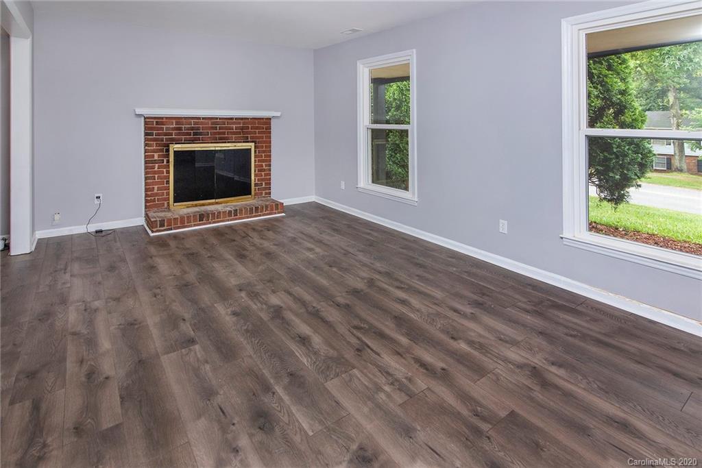 5720 Lawrence Orr Road Charlotte, NC 28212 - Photo 3 of 19 a view of empty room with window and fireplace
