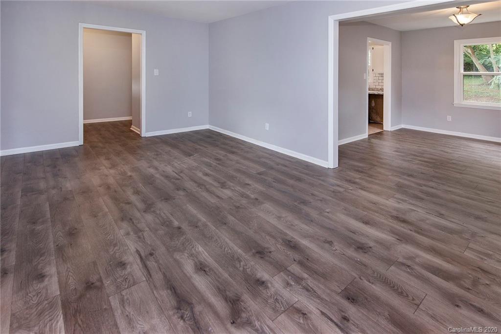 5720 Lawrence Orr Road Charlotte, NC 28212 - Photo 5 of 19 a view of an empty room with wooden floor and a window