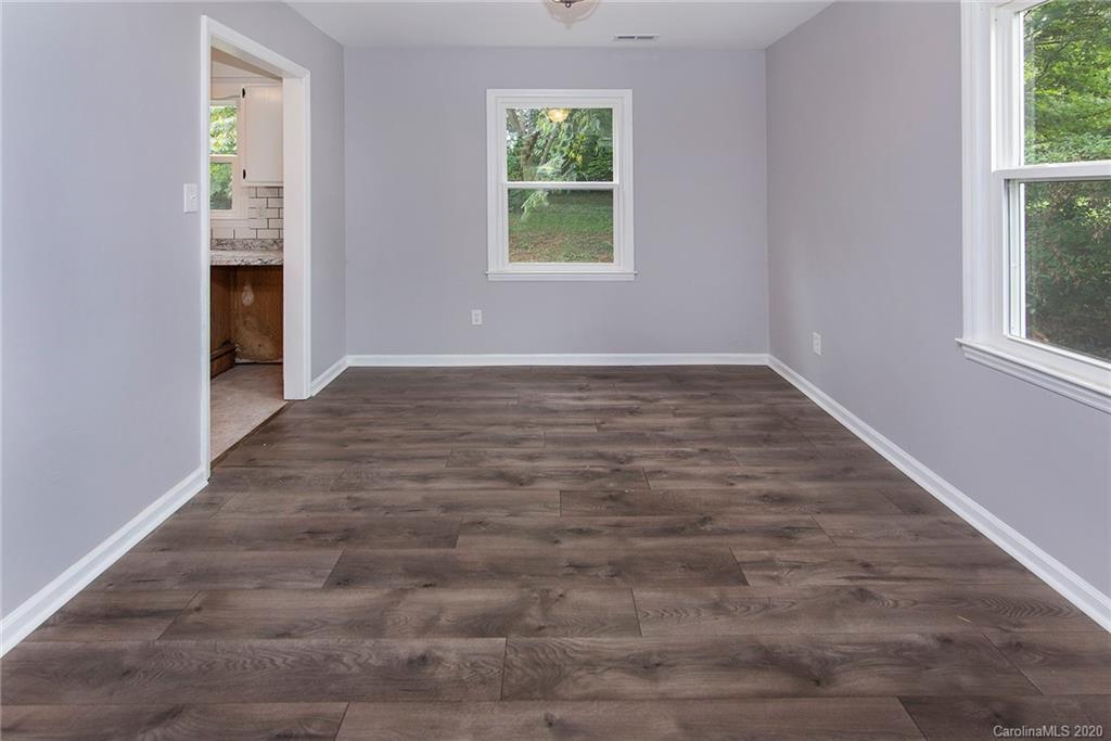 5720 Lawrence Orr Road Charlotte, NC 28212 - Photo 6 of 19 a view of an empty room with wooden floor and a window