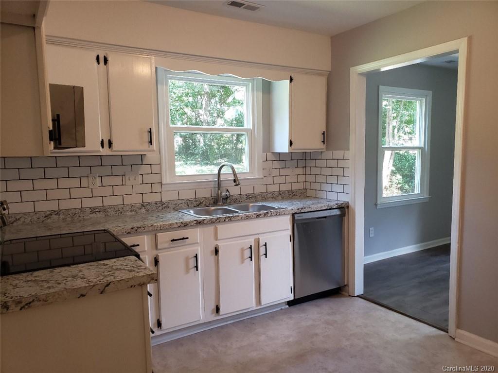 5720 Lawrence Orr Road Charlotte, NC 28212 - Photo 8 of 19 a kitchen with a sink stove and cabinets