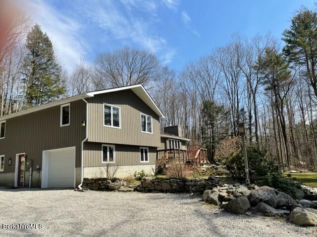 76 Louden Bethlehem Road Otis, MA 01253 - Photo 1 of 54 a front view of a house with a garden