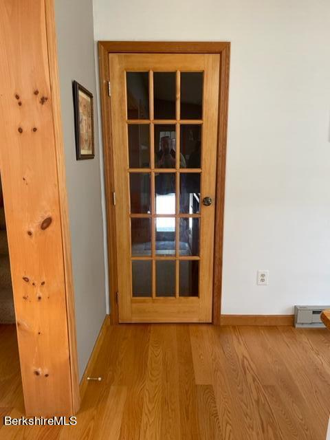76 Louden Bethlehem Road Otis, MA 01253 - Photo 23 of 54 an empty room with wooden floor and windows