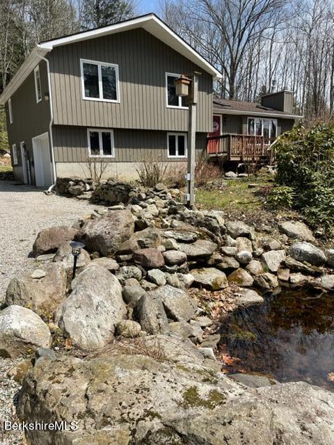 76 Louden Bethlehem Road Otis, MA 01253 - Photo 6 of 54 a front view of a house with a yard