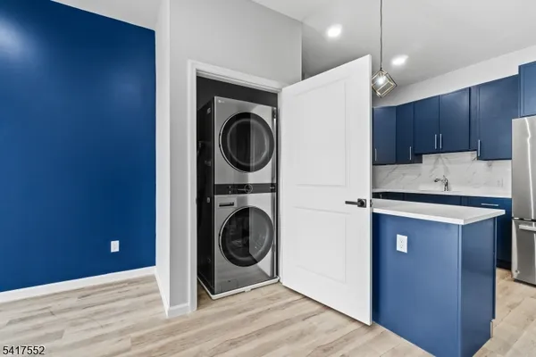 a kitchen with a stove top oven a washer and dryer