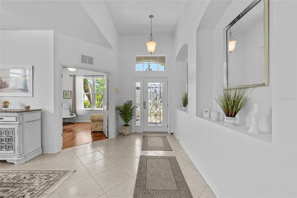 a very nice looking room with a large window and white walls