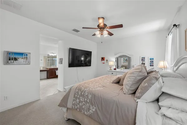 a bedroom with a large bed and a flat screen tv