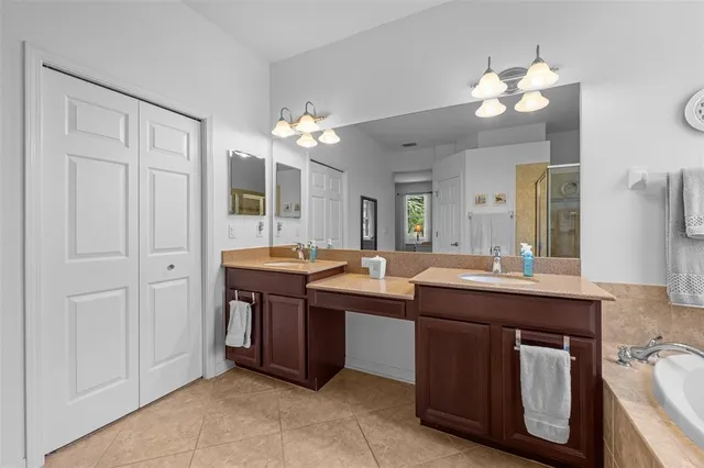 a spacious bathroom with a double vanity sink and a mirror