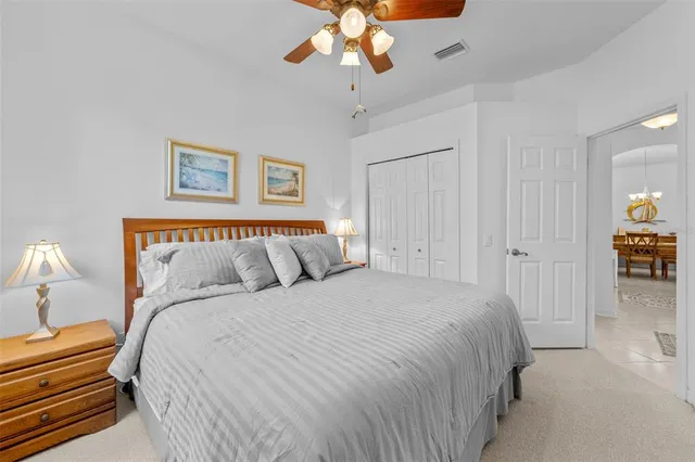a spacious bedroom with a bed and a chandelier
