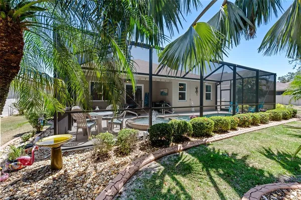 a view of backyard of house with outdoor seating and green space