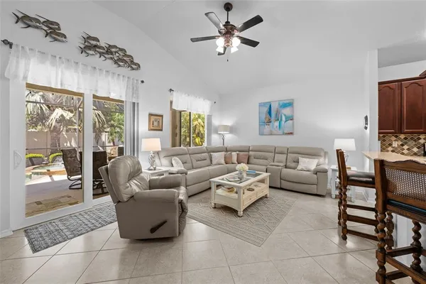 a living room with furniture ceiling fan and a window