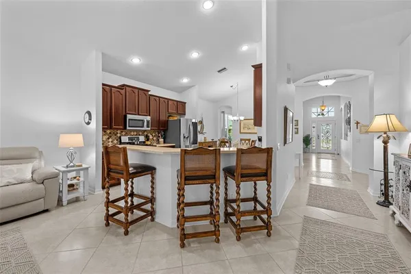 a kitchen with stainless steel appliances kitchen island granite countertop a table and chairs in it