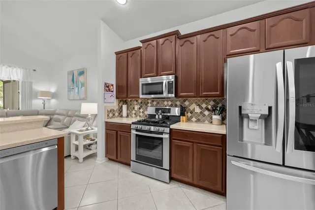 a kitchen with stainless steel appliances and wooden cabinets