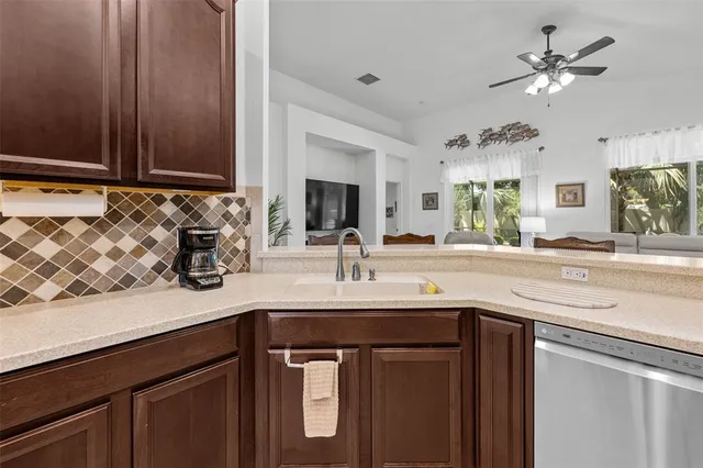 a sink with a granite top and mirror