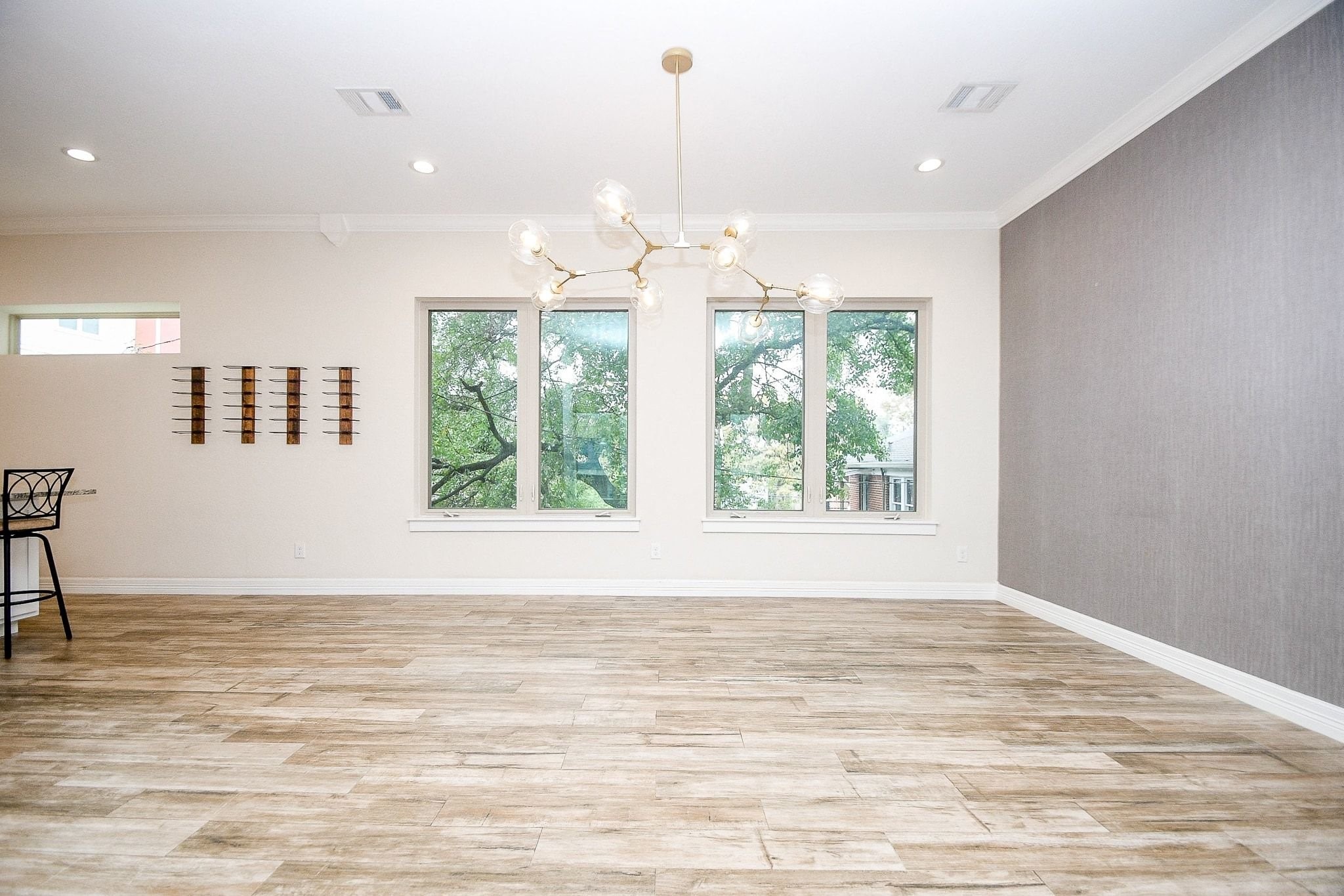 710 Stanford Street, Unit B Houston, TX 77019 - Photo 11 of 33 a view of an empty room with wooden floor and a window