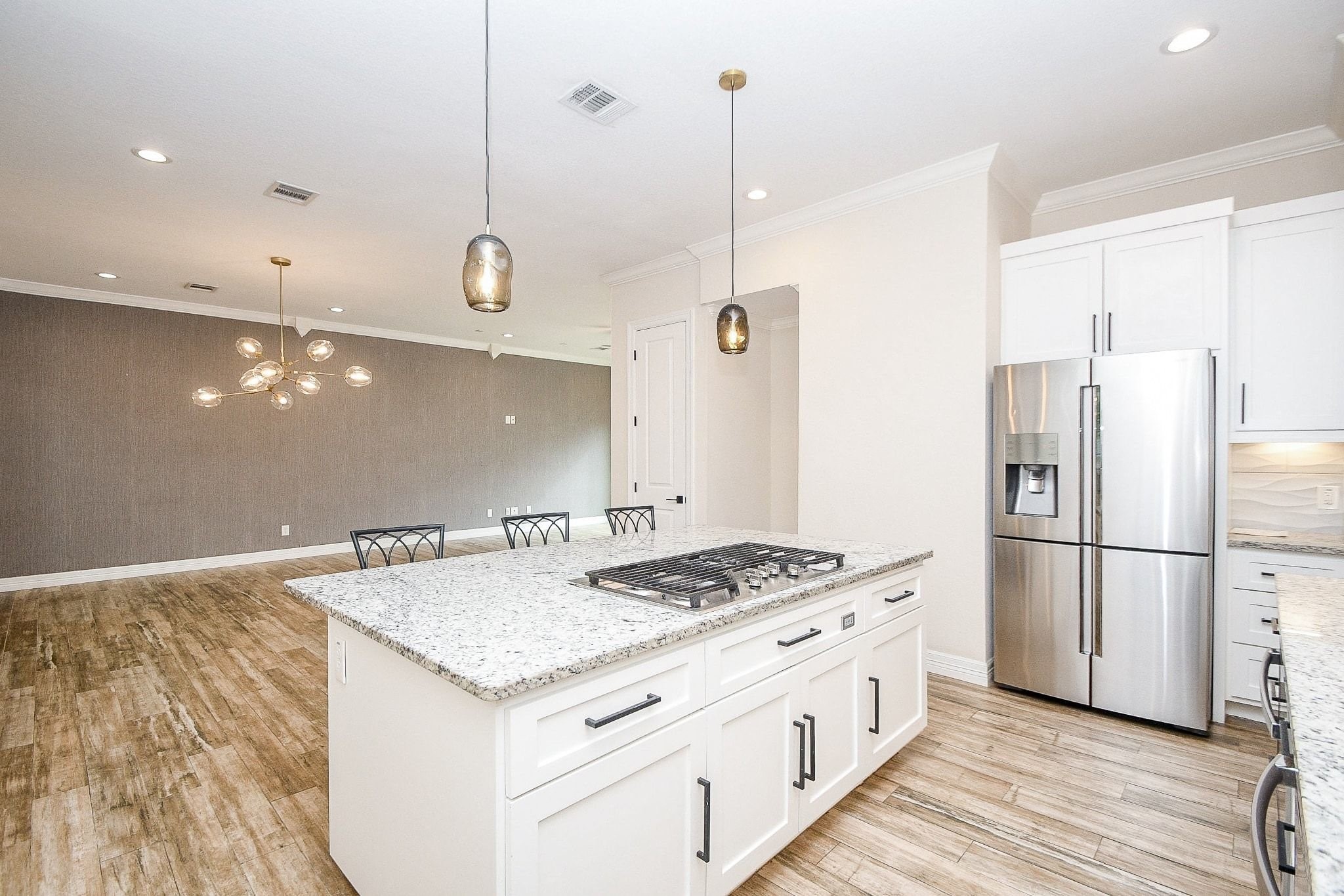 710 Stanford Street, Unit B Houston, TX 77019 - Photo 16 of 33 a kitchen with a refrigerator a sink and wooden floor