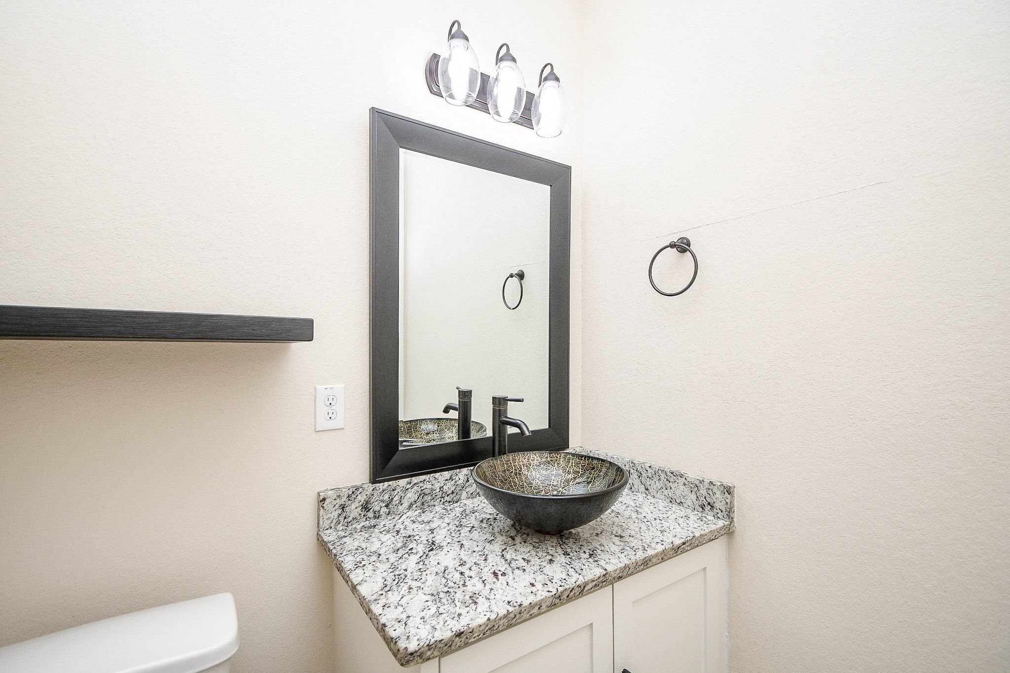 710 Stanford Street, Unit B Houston, TX 77019 - Photo 19 of 33 a bathroom with a granite countertop sink and a mirror