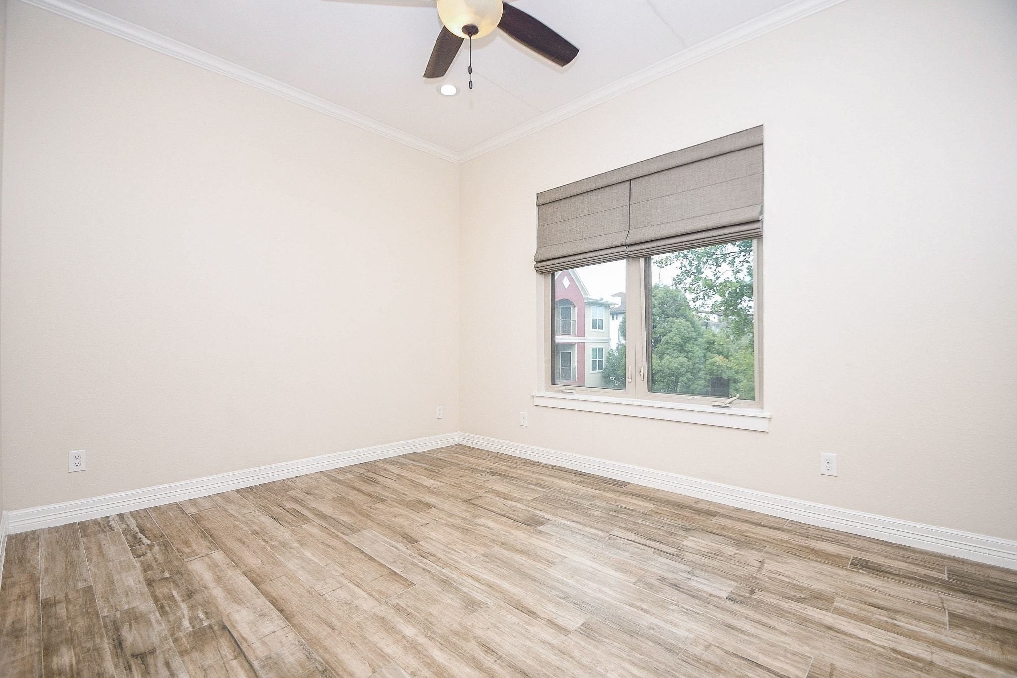 710 Stanford Street, Unit B Houston, TX 77019 - Photo 7 of 33 an empty room with a window and wooden floor