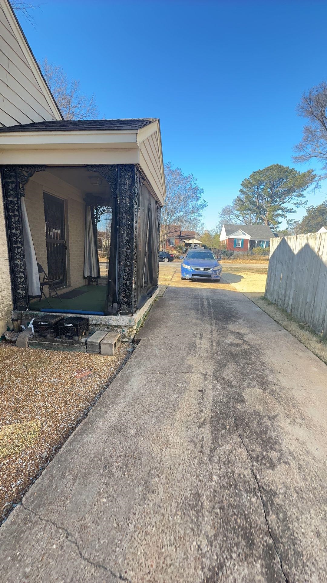 1148 Mt Vernon Road Memphis, TN 38111 - Photo 2 of 17 Side entrance featuring a covered porch with decorative black metalwork, a concrete driveway, and a gravel border