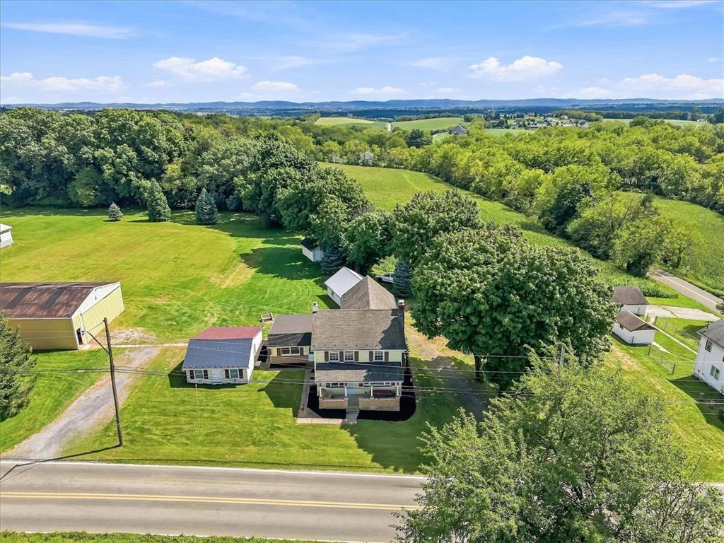 2412 Clearview Road Coplay, PA 18037 - Photo 40 of 53 An aerial perspective showcases a rural homestead surrounded by rolling hills and mature trees.
