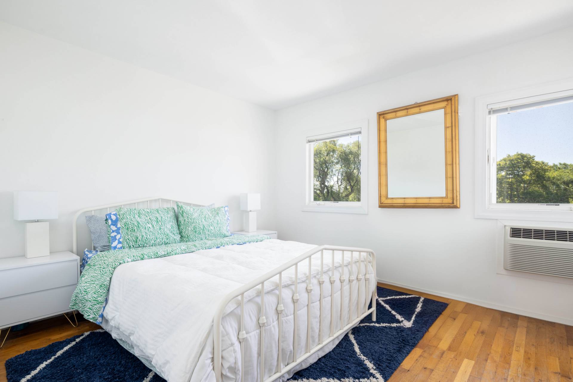 3045 Mitchell Road Westhampton Beach, NY 11978 - Photo 12 of 25 a bedroom with a bed and wooden floor