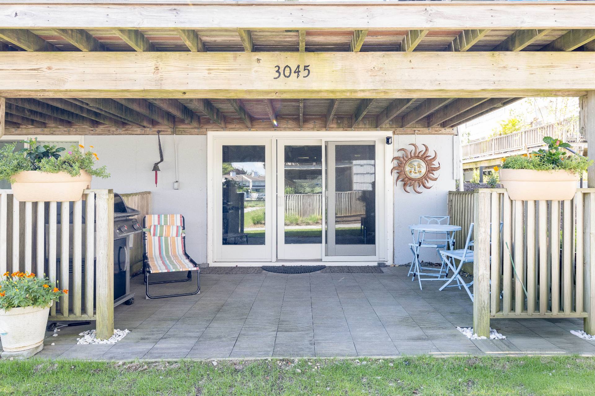 3045 Mitchell Road Westhampton Beach, NY 11978 - Photo 18 of 25 a view of a porch with a floor to ceiling window and yard